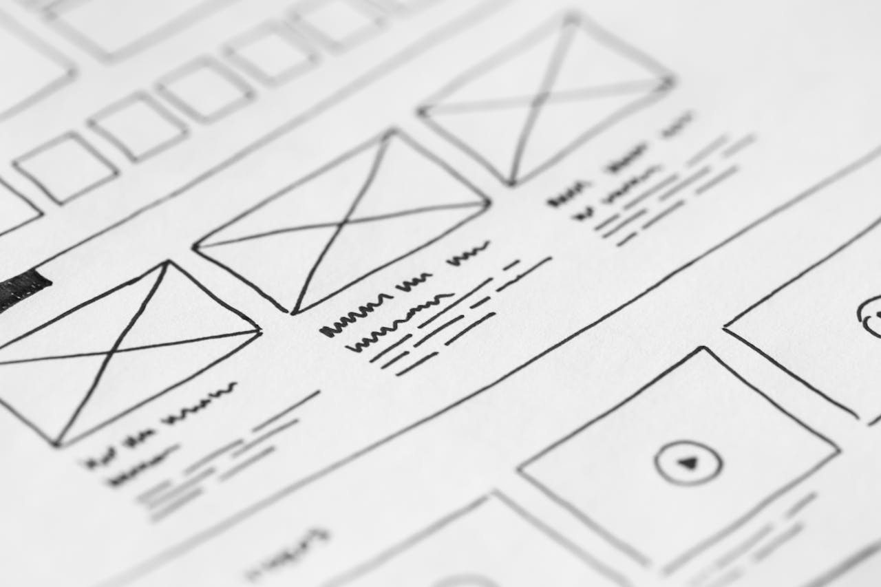 gallery-1 Detailed close-up of a hand-drawn wireframe design on paper for a UX project.
